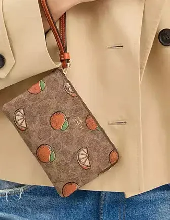 Coach Corner Zip Wristlet In Signature Canvas With Orange Print